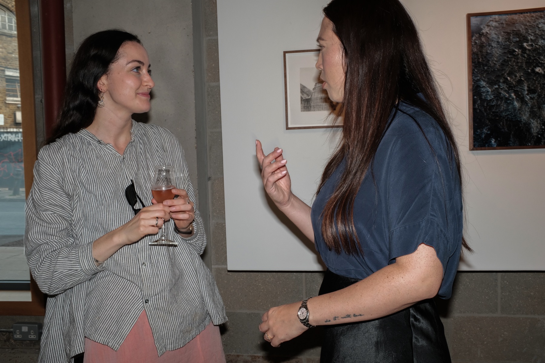 Two guests in conversation beside the work