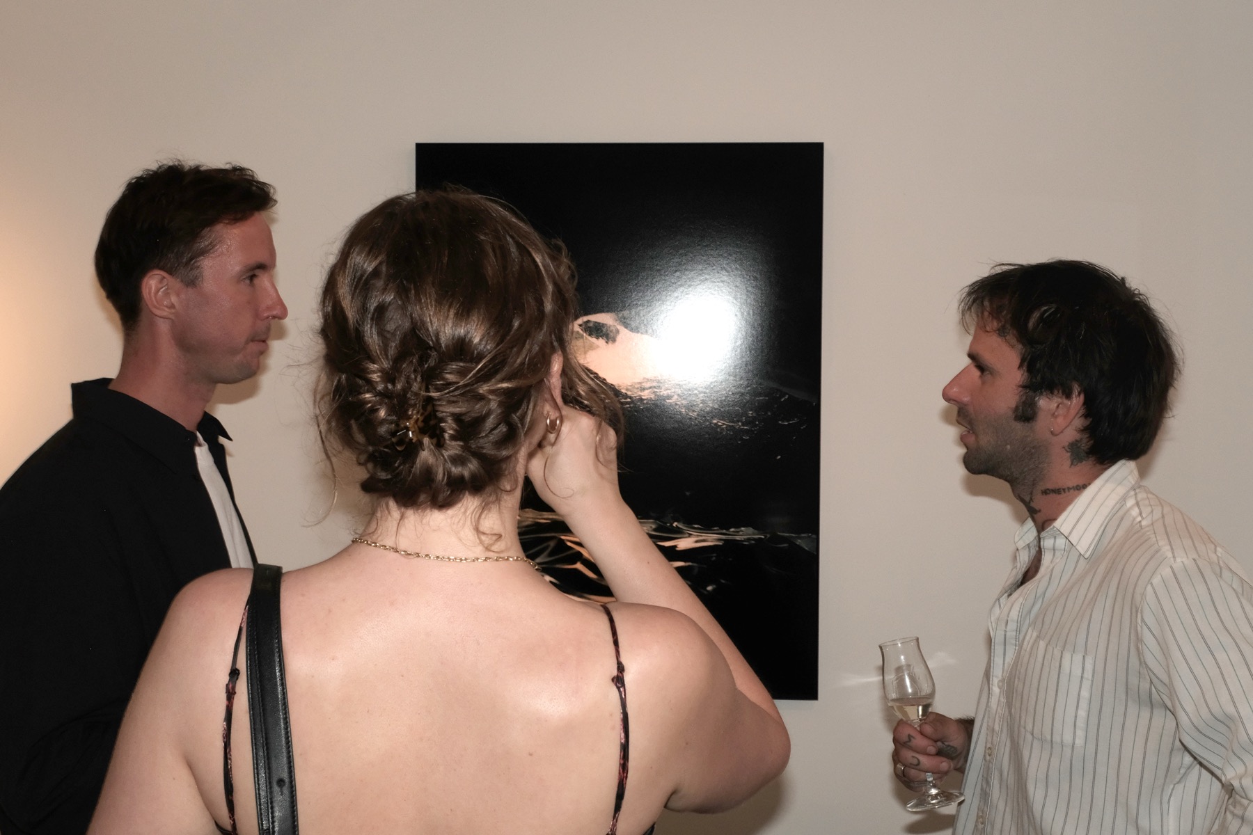 Three guests in front of a photograph